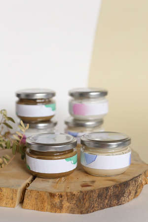 Eco friendly Glass Bottle or jar with natural skincare cosmetics, creams or oils on light background. Plant-based beauty productsの写真素材