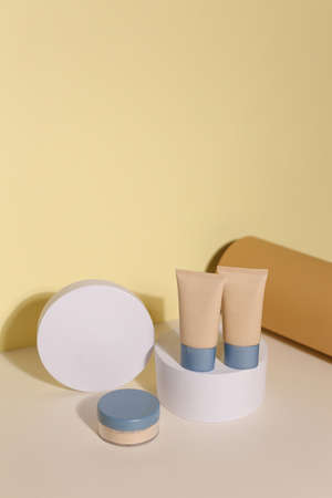 Foundation face make-up samples. Set of cosmetic liquid foundation or bb cream in bottle colour. Make up smears isolated on beige backgroundの写真素材