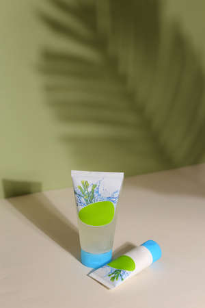 Eco friendly tubes with natural skincare cosmetics, creams or oils on light background. Plant-based beauty productsの写真素材