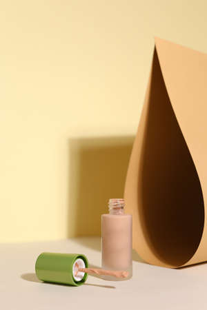 Foundation face make-up samples. Set of cosmetic liquid foundation or bb cream in bottle colour. Make up smears isolated on beige backgroundの写真素材