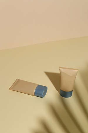 Foundation face make-up samples. Set of cosmetic liquid foundation or bb cream in bottle colour. Make up smears isolated on beige backgroundの写真素材