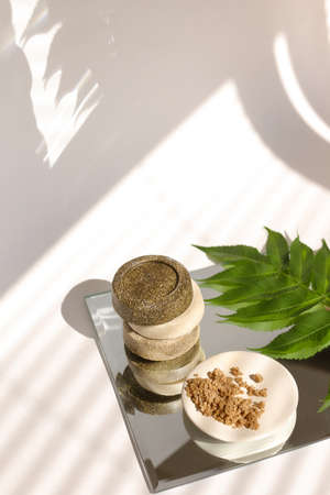 Oatmeal flakes skin care treatment. Rolled oats scattered, body scrubber, handmade soap bar.の写真素材