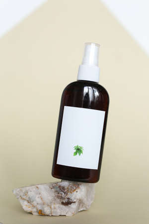 Eco friendly Bottle or jar with natural skincare cosmetics, creams or oils on rock, light background. Plant-based beauty productsの写真素材