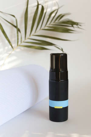 beauty hygiene plastic bottle on white background with green leavesの写真素材