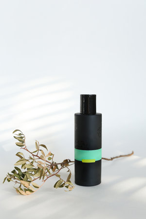 beauty hygiene plastic bottle on white background with green leavesの写真素材