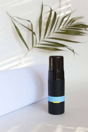 beauty hygiene plastic bottle on white background with green leavesの写真素材