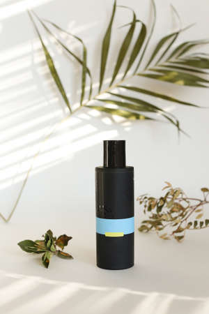 beauty hygiene plastic bottle on white background with green leavesの写真素材