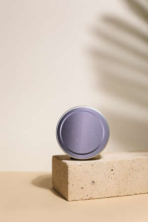 White cream in round aluminum metal tin on neutral background. Natural cosmetic product. Face and body skin care, cosmetic products.の写真素材