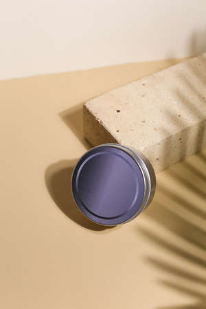 White cream in round aluminum metal tin on neutral background. Natural cosmetic product. Face and body skin care, cosmetic products.の写真素材
