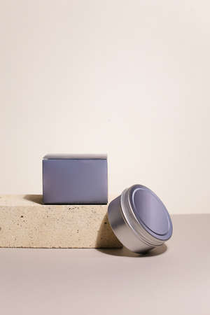 White cream in round aluminum metal tin on neutral background. Natural cosmetic product. Face and body skin care, cosmetic products.の写真素材