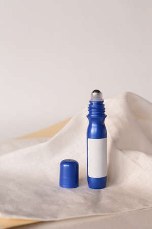 Anti aging serum in plastic bottle with roller on white background. Facial liquid serum with collagen and peptides.の写真素材
