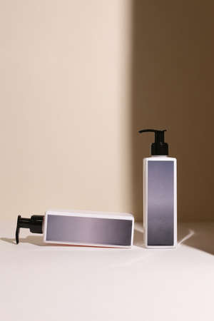 Beauty natural skincare products development concept. Dermatologist cosmetic skincare bottle with pump dispenser and organic ingredient on neutral background.の写真素材