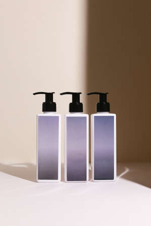 Beauty natural skincare products development concept. Dermatologist cosmetic skincare bottle with pump dispenser and organic ingredient on neutral background.の写真素材