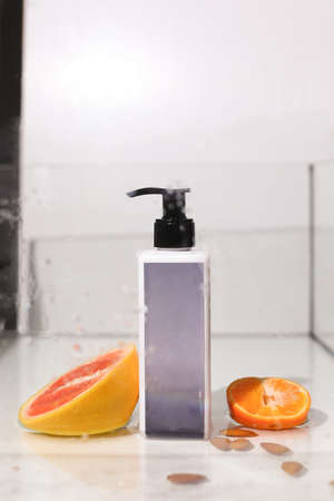 Beauty natural skincare products development concept. Dermatologist cosmetic skincare bottle with pump dispenser and organic ingredient on neutral background.の写真素材