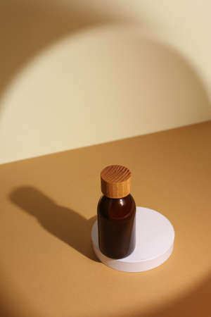 Mans cosmetics for hair in the glass bottle on neutral backgroundの写真素材