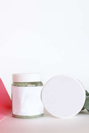 Set of cosmetic cream jars, isolated on beige or gray background with shadow and rockの写真素材