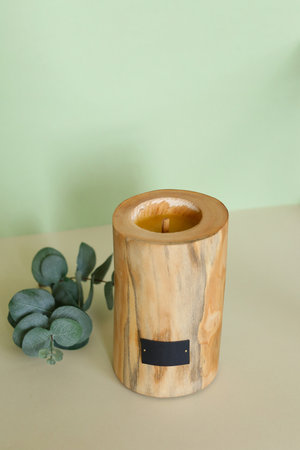 Wooden candle holder rustic interior centerpiece with candles in a cozy barn setting.の写真素材