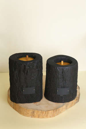 Wooden candle holder rustic interior centerpiece with candles in a cozy barn setting.の写真素材