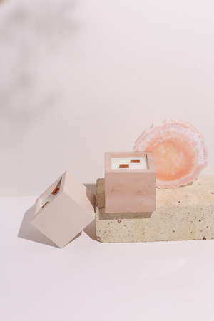 scented candles on off white background in rock holderの写真素材
