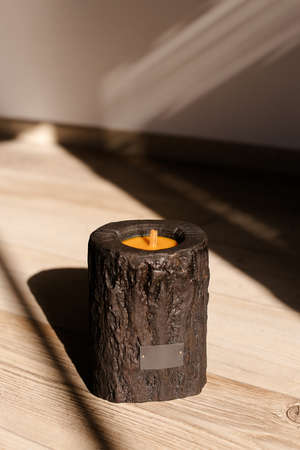 Wooden candle holder rustic interior centerpiece with candles in a cozy barn setting.の写真素材