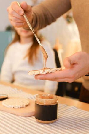 Dad and daughter enjoy peanut or almond butter, peanut butter sandwichの写真素材