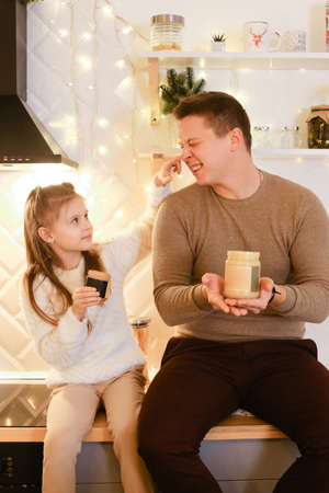 Dad and daughter enjoy peanut or almond butter, peanut butter sandwichの写真素材