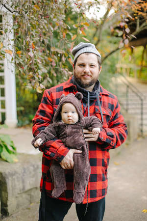 Caucasain father holding newborn baby outside.の写真素材