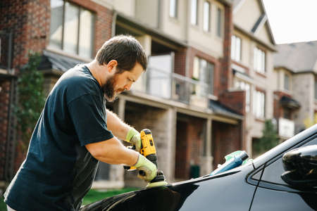Auto service Canadian staff man cleaning car and polishingの写真素材
