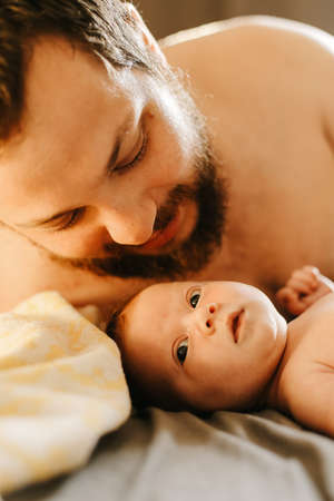 Close up caucasian portrait of father holding newborn baby.の写真素材