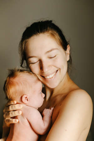 Portrait of mother holding new born baby.の写真素材