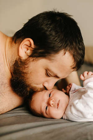 Close up portrait of american father holding newborn baby.の写真素材