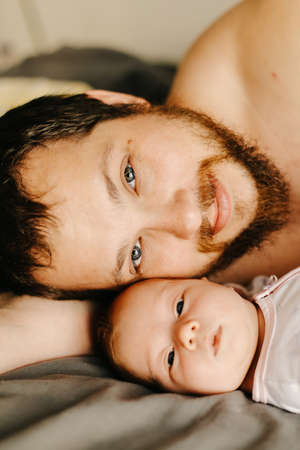 Close up portrait of american happy father holding newborn baby.の写真素材