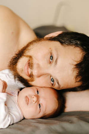 Close up portrait of happy father holding newborn baby.の写真素材