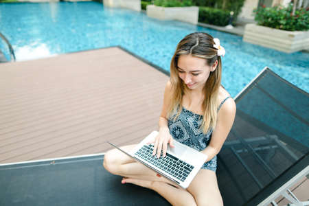 woman working uses internet and laptop pc outdoors remotely as fの写真素材