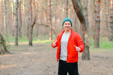 Young man running in park at morning.の写真素材