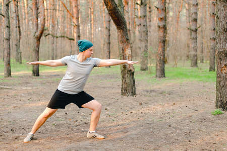 Male person resting and doing workout in morning park.の写真素材