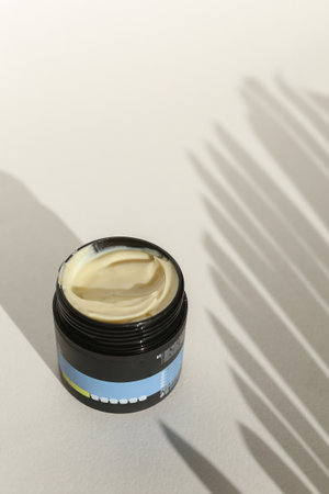 Cosmetic cream container with face or body cream on neutral backgroundの写真素材