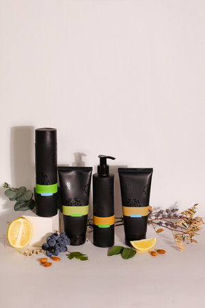 Eco friendly Bottle and tube with natural skincare cosmetics, creams or oils on light background. Plant-based beauty productsの写真素材