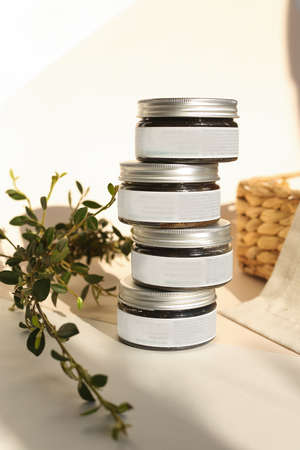 plastic jar with cream and lid isolated on neutral light background. Beauty spa and taking care of skin productの写真素材