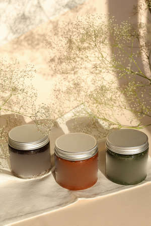 plastic jar with cream and lid isolated on neutral light background. Beauty spa and taking care of skin productの写真素材