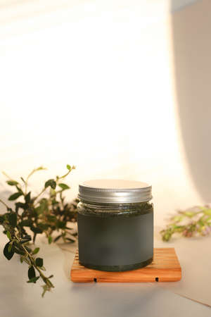 plastic jar with cream and lid isolated on neutral light background. Beauty spa and taking care of skin productの写真素材