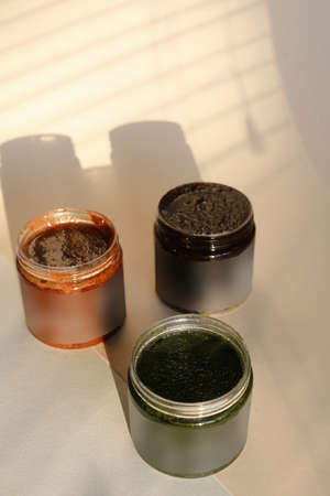 plastic jar with cream and lid isolated on neutral light background. Beauty spa and taking care of skin productの写真素材