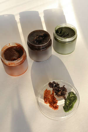 plastic jar with cream and lid isolated on neutral light background. Beauty spa and taking care of skin productの写真素材