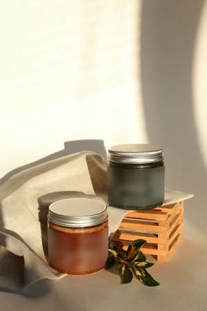 plastic jar with cream and lid isolated on neutral light background. Beauty spa and taking care of skin productの写真素材