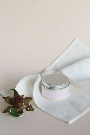 plastic jar with cream and lid isolated on neutral light background. Beauty spa and taking care of skin productの写真素材