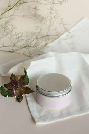 plastic jar with cream and lid isolated on neutral light background. Beauty spa and taking care of skin productの写真素材