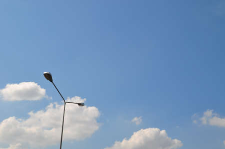 Electric light in the blue sky and cloudsの写真素材