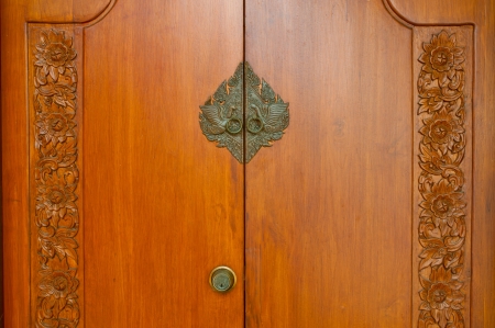 Brown carved wooden doors and locks の写真素材