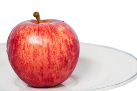 Red apple on a plate and white background の写真素材