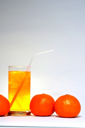 Glass of orange juice and citrus fruits の写真素材
